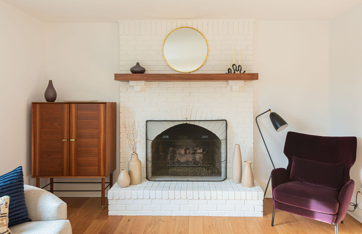 Brick fireplace with wood mantel in New Jersey living room