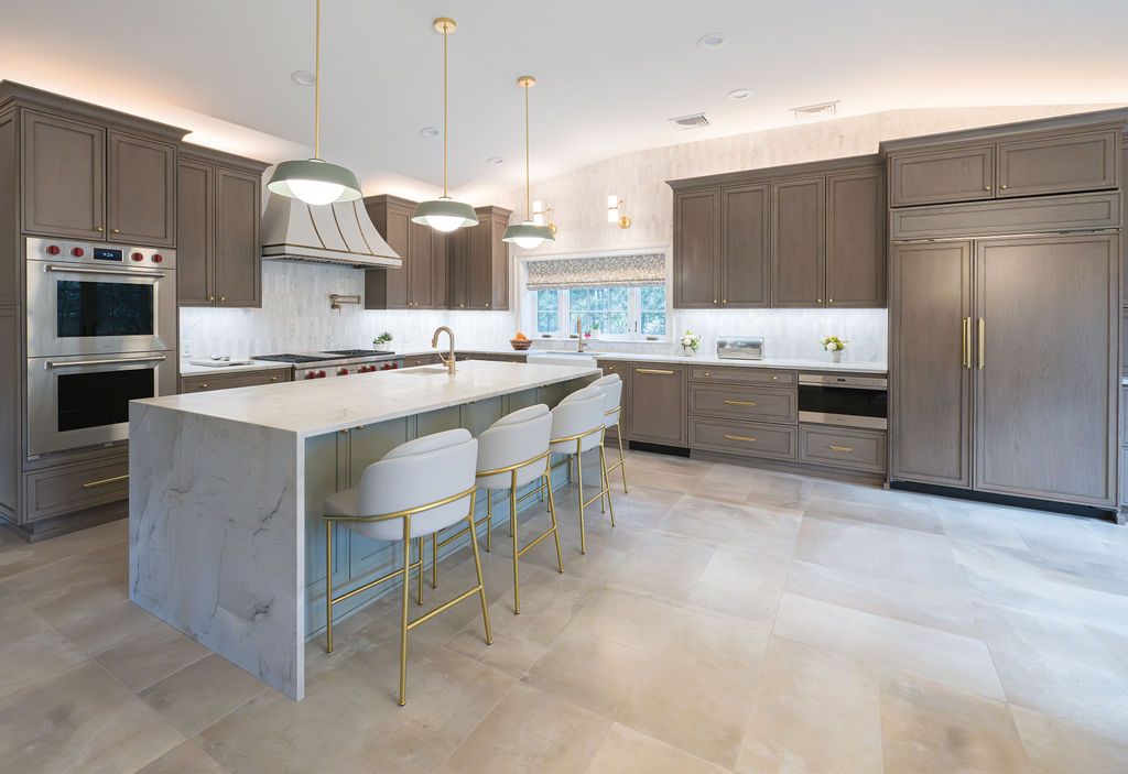 Custom kitchen remodel in Caldwell, NJ by G&L and Sons Renovations featuring taupe cabinets and marble waterfall island