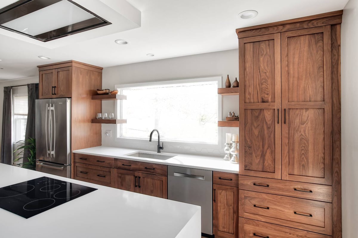 Modern kitchen design in Short Hills, NJ featuring walnut cabinetry and white countertops by G&L and Sons Renovations