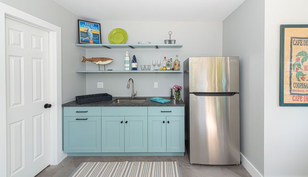 Built-in kitchenette with beach-themed accents and modern appliances in a Caldwell, NJ custom home by G&L and Sons Renovations