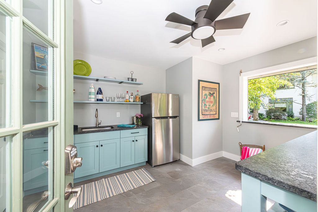 Contemporary wet bar in East Hanover, NJ featuring blue cabinetry and stainless appliances by G&L and Sons Renovations
