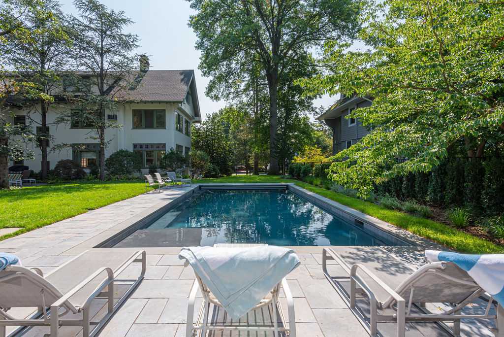 Glen Ridge, NJ luxury backyard remodel with rectangular pool and lounge chairs by G&L and Sons Renovations