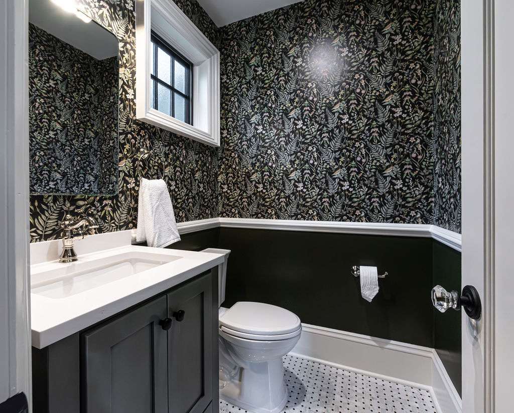 Powder room remodel in Fairfield, NJ with floral wallpaper and dark green vanity by G&L and Sons Renovations