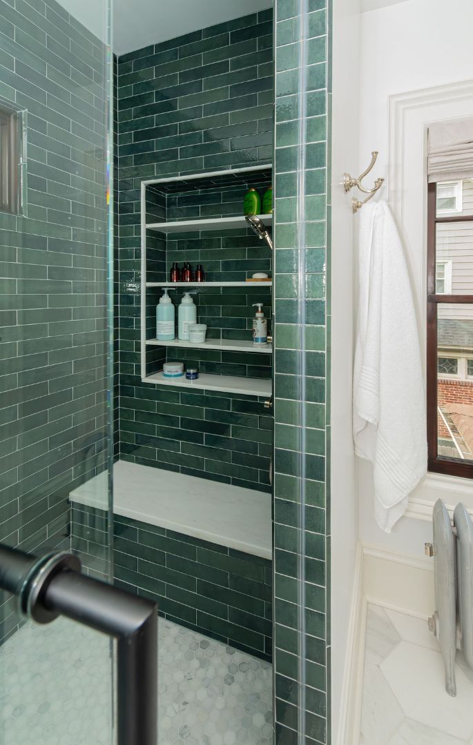 Detailed view of emerald green shower tile with recessed shelf and built-in bench by G&L and Sons Renovations in Caldwell, NJ