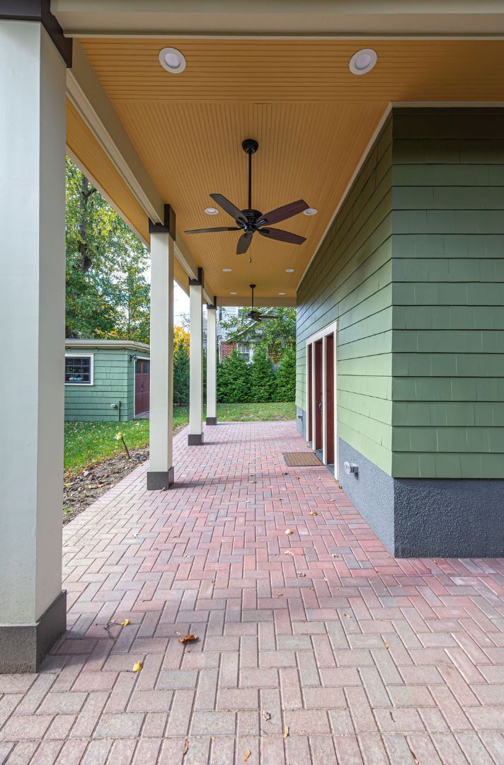 Covered side patio in West Orange, NJ with ceiling fans by G&L and Sons Renovations
