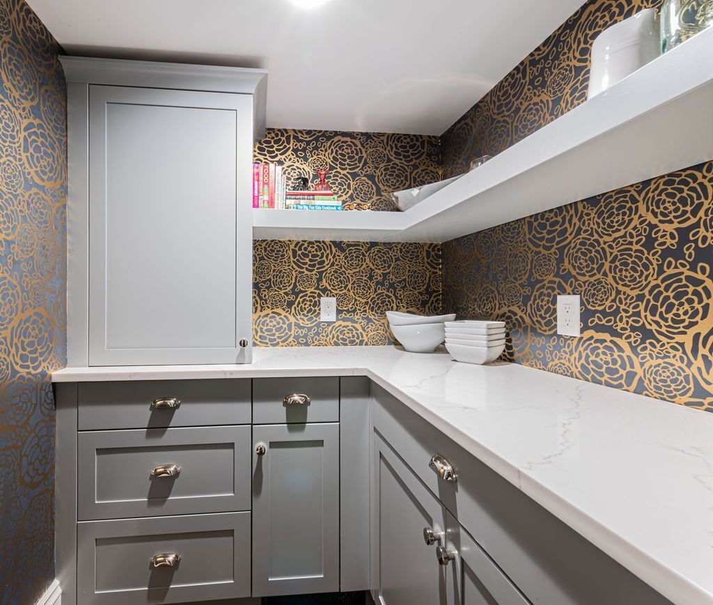 G&L and Sons Renovations stylish pantry with gold and navy wallpaper in West Orange, NJ