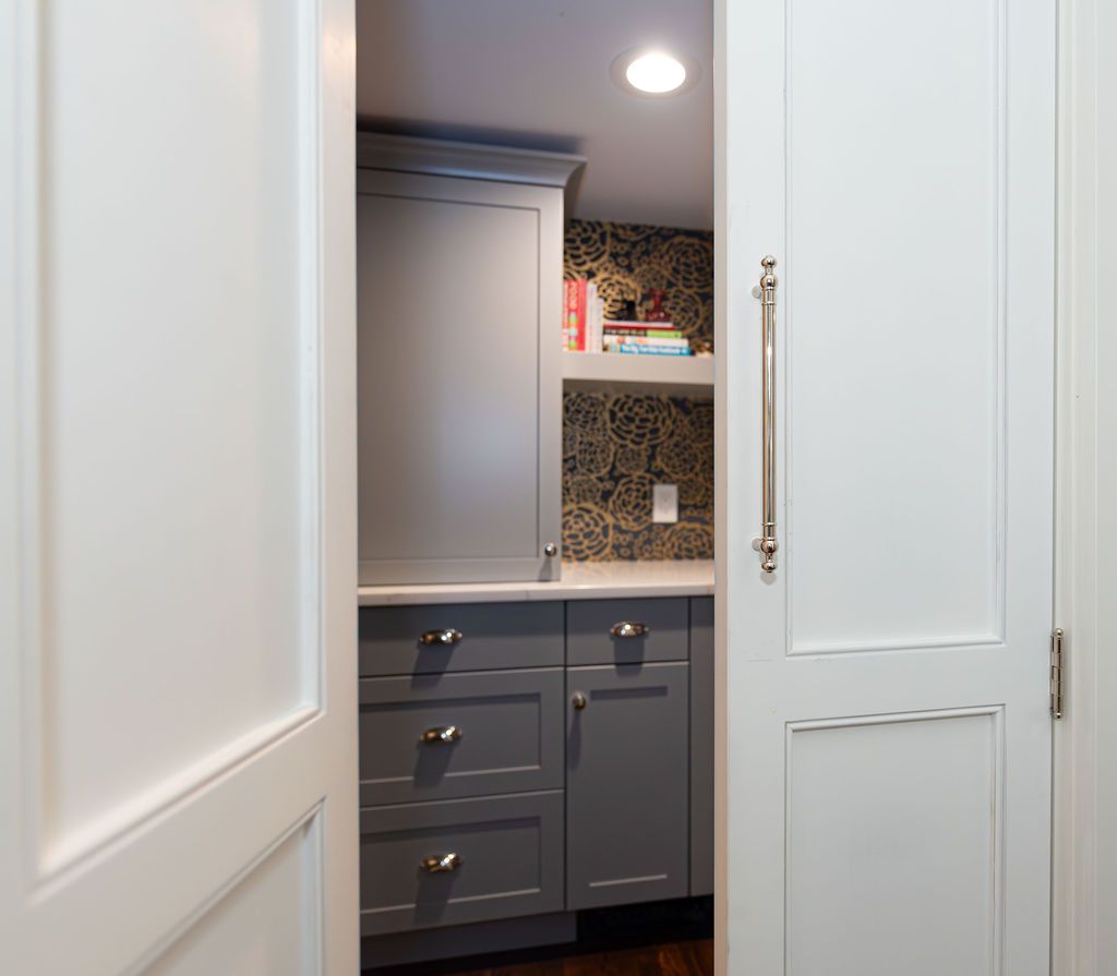 Secret pantry nook with custom cabinetry and shelving in a Caldwell, NJ custom home by G&L and Sons Renovations