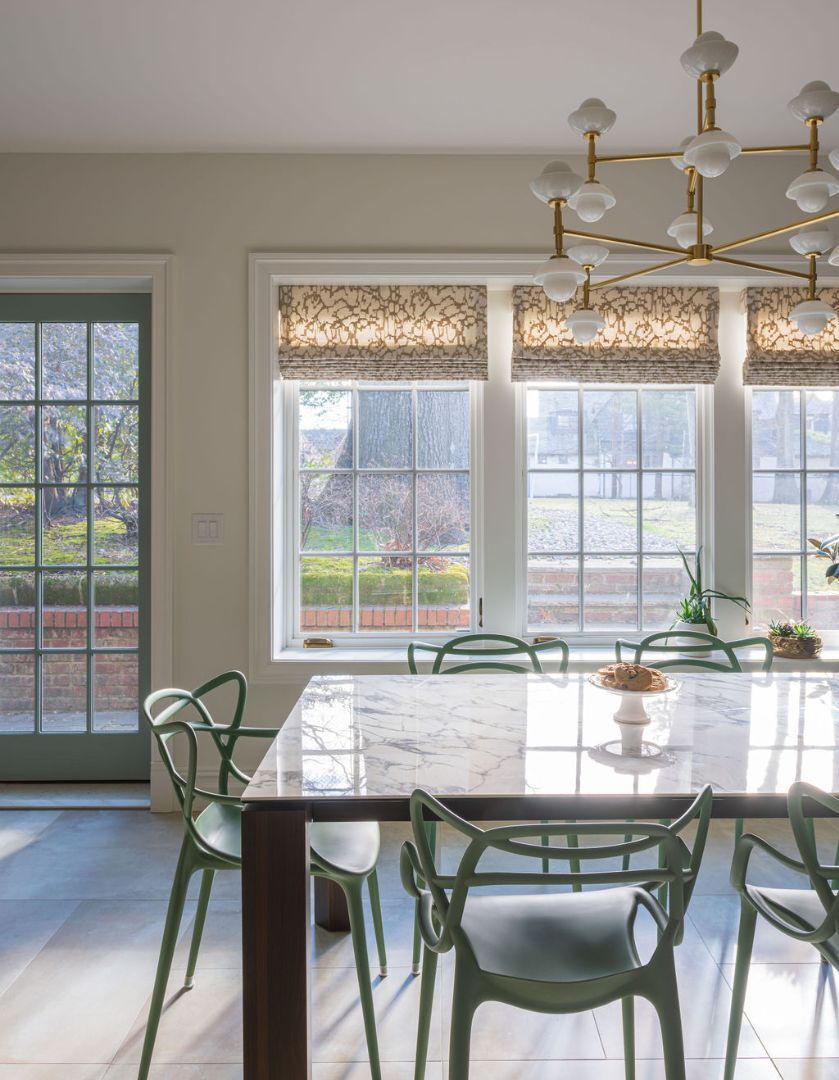 Dining area with marble table and brass chandelier in Glen Ridge, NJ by G&L and Sons Renovations