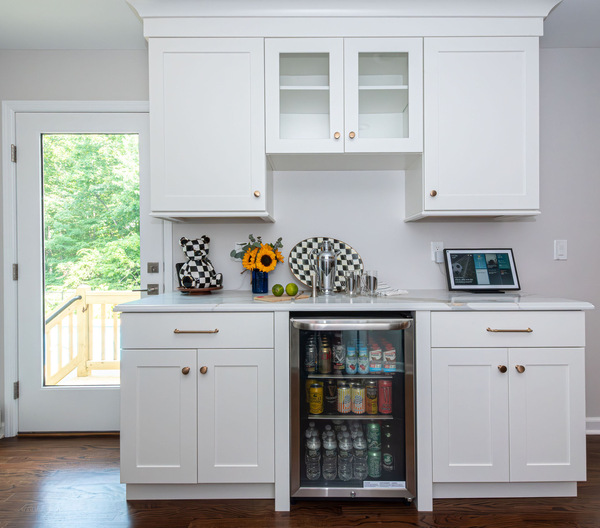 Built-in bar with white cabinets and wine fridge