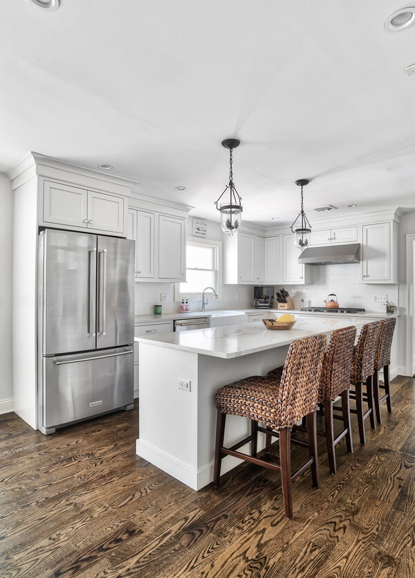 Bright, white kitchen remodel with stainless steel appliances and white cabinets